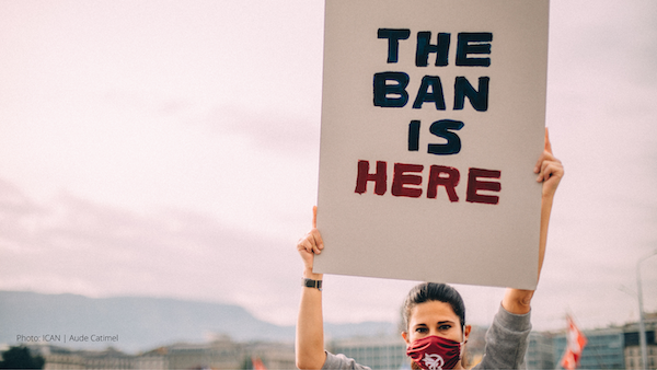 woman holding message; the ban is here
